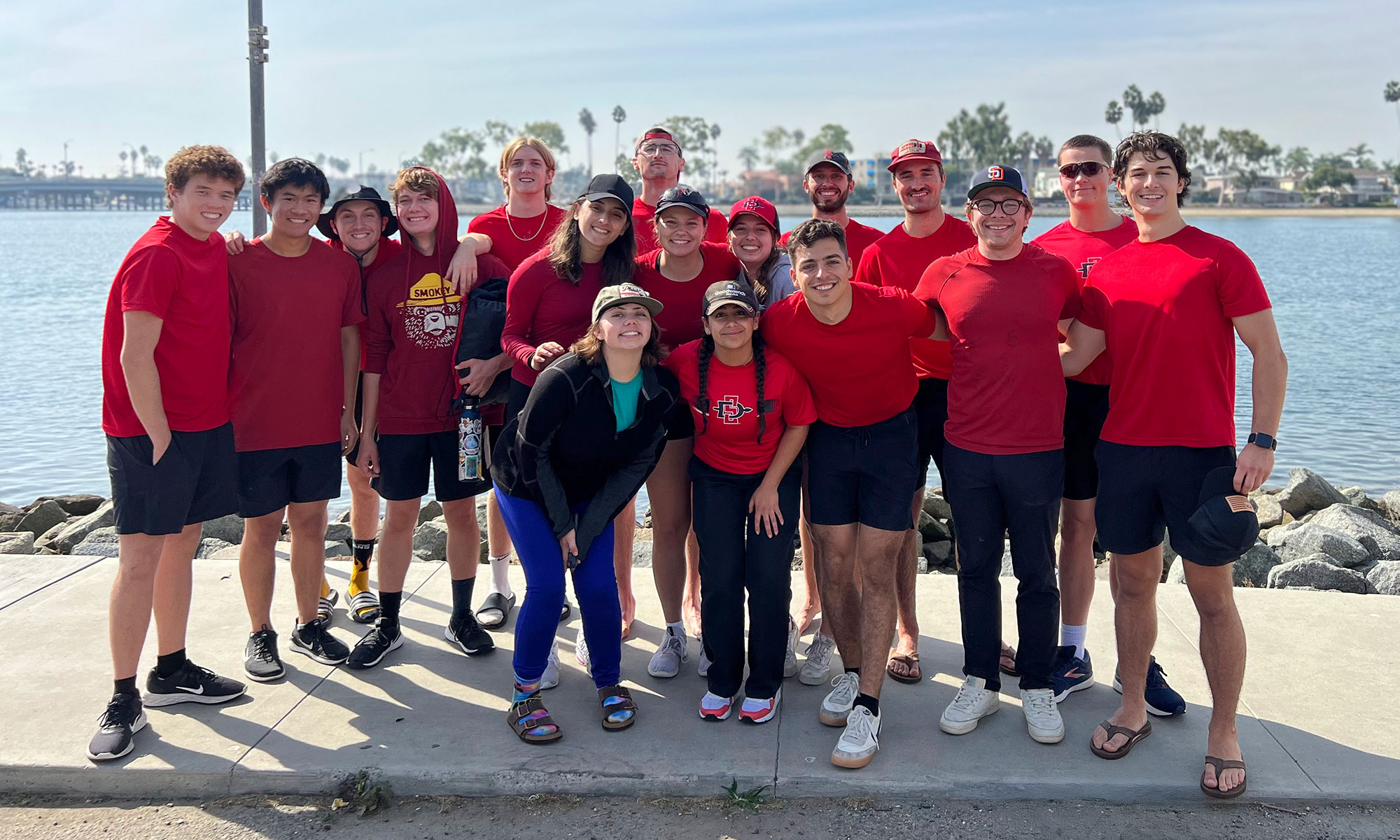 SDSU Rowing team group photo near the ocean