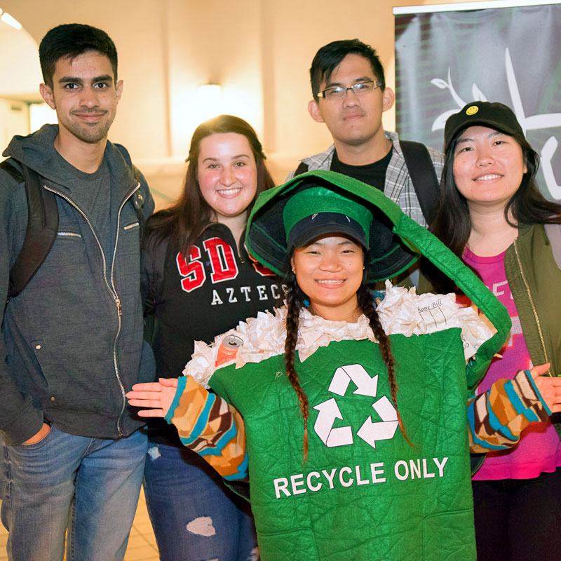 Student wearing recycle bin costume with friends