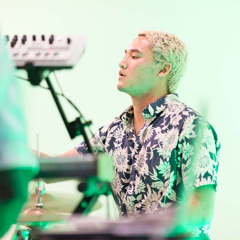Male student playing the drums