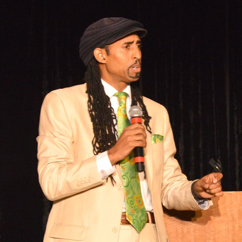 Mustafa Santiago Ali holding a microphone