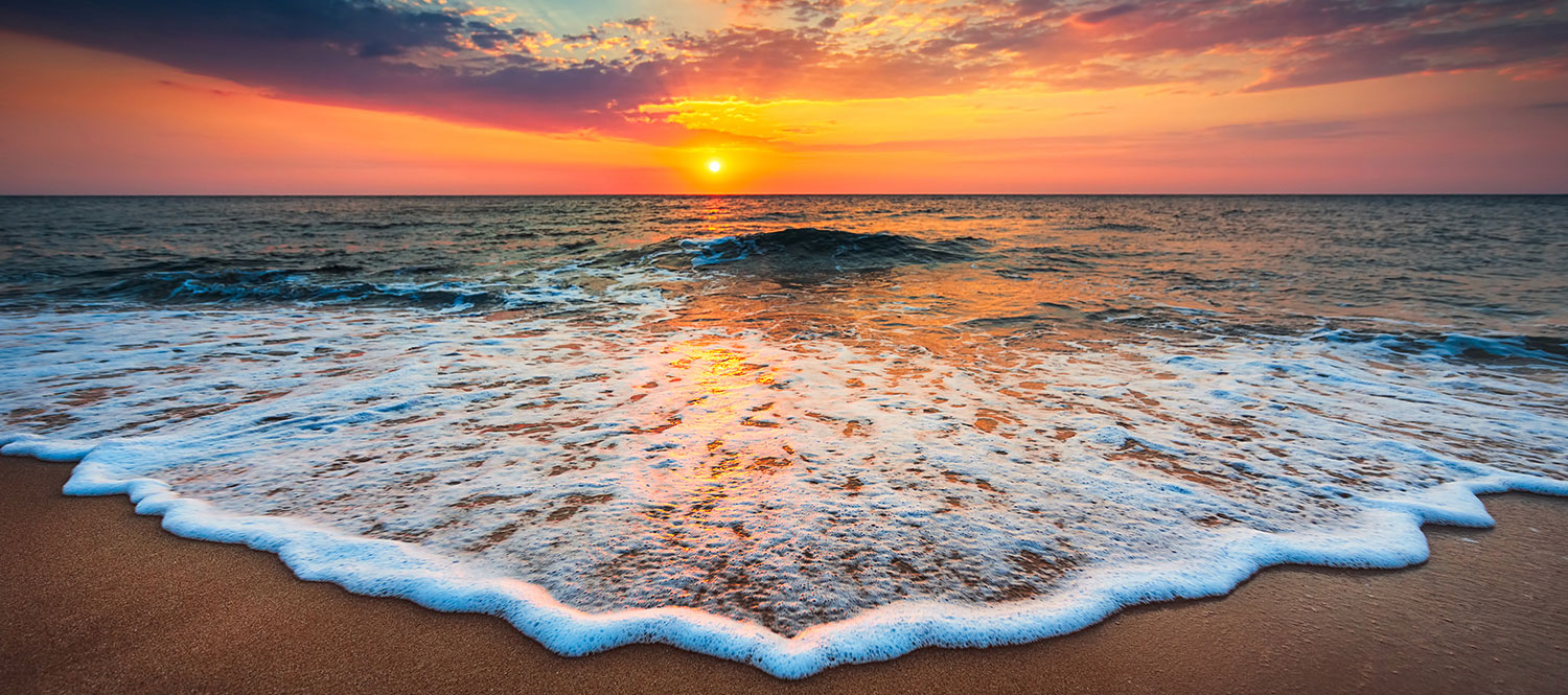 Beach surf at sunset