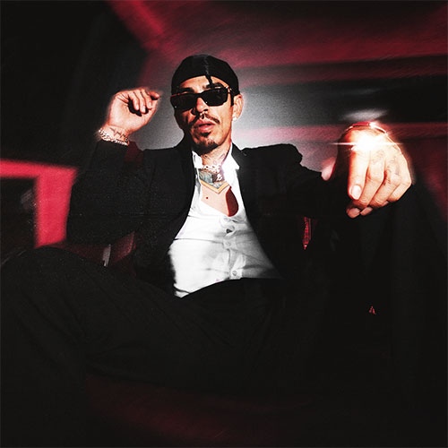  Codiciado sitting in a suit with sunglasses  - Event