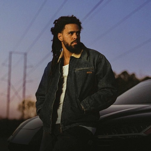  J Cole leaning against a car at sunset  - Event