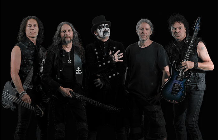 King Diamond members with 3 guitars against black background  Photo