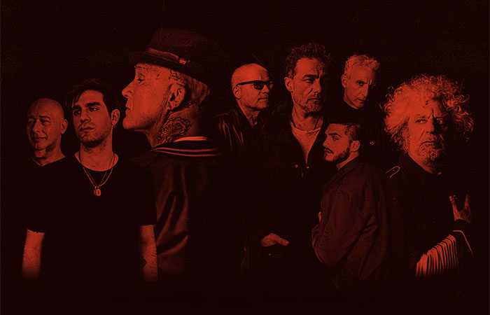 Los Fabulosos Cadillacs members in red on black background Photo