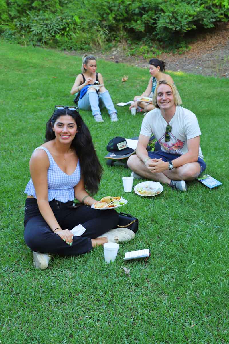 Graduate students having lunch on grass at GA Event