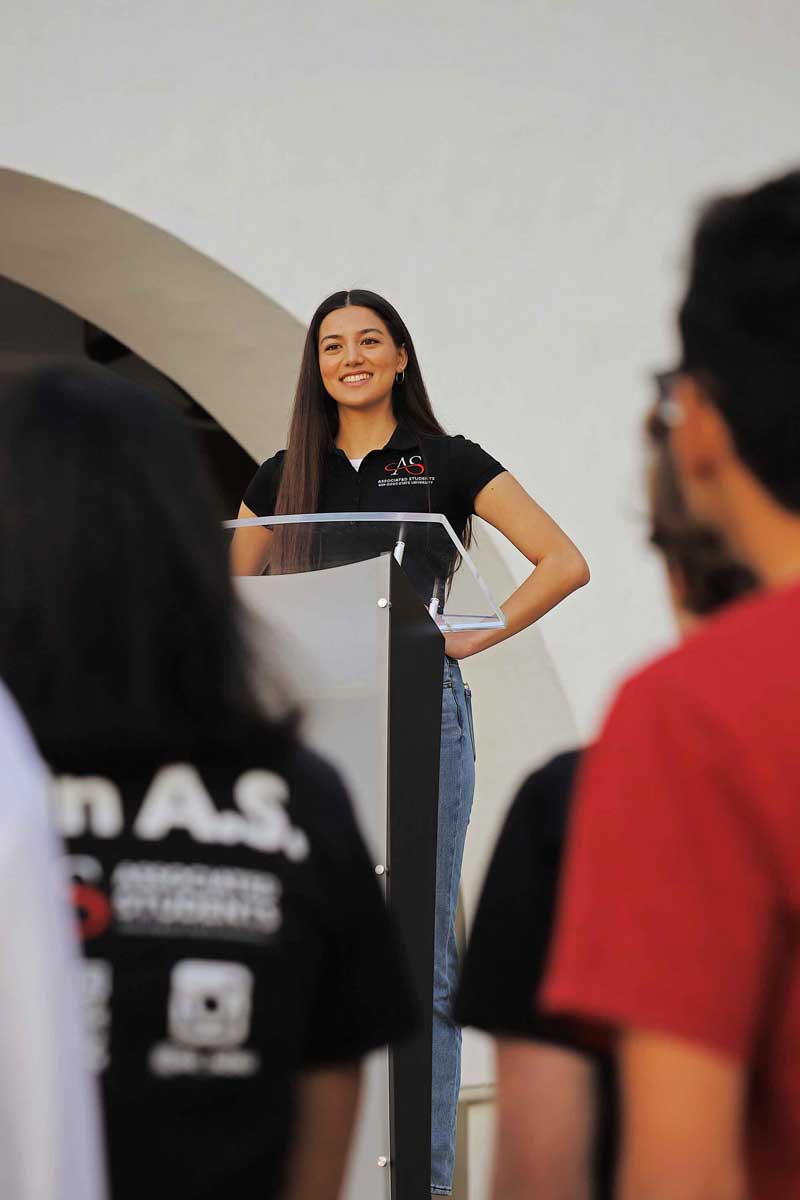 SDSU student at the podium in front of a crowd