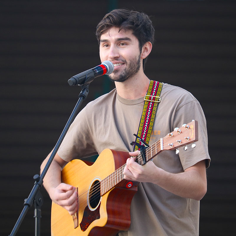 Man playing a guitar and singing