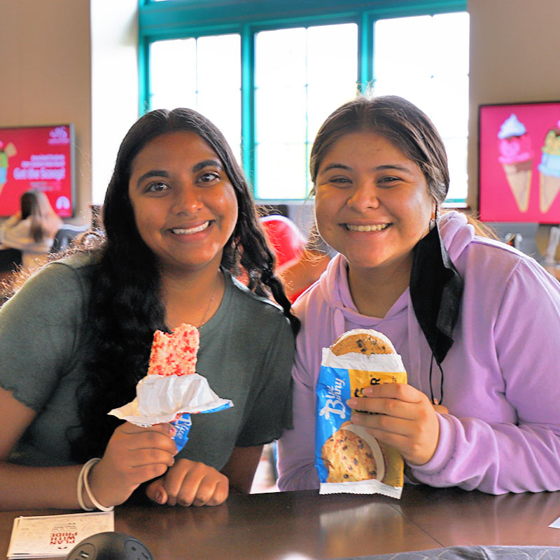 Two students eating ice cream at Get a Scoop event
