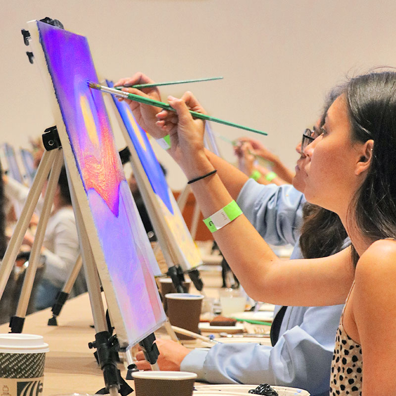 Students learning hor to paint on canvas