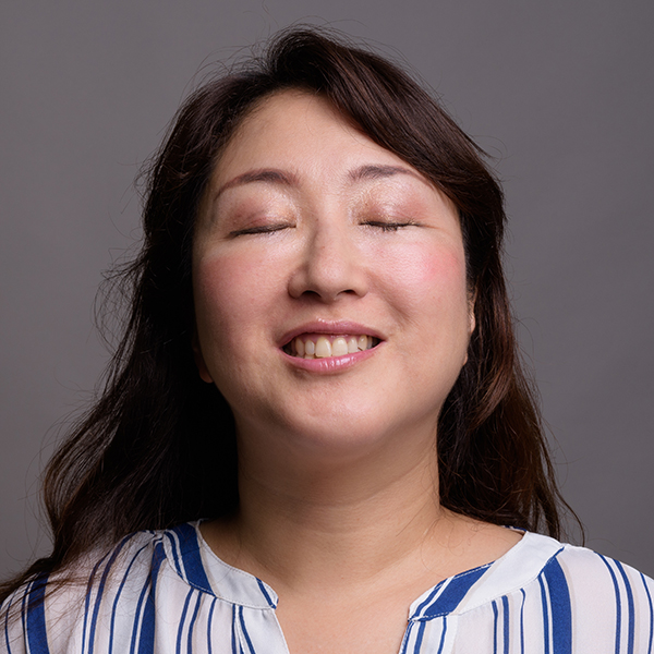 Photo of woman with her eyes closed smiling