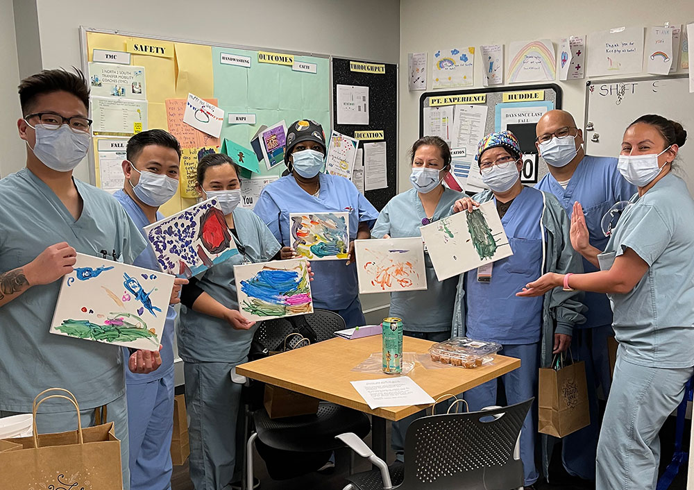 Staff members at Sharp Grossmont Hospital with the children's painting.