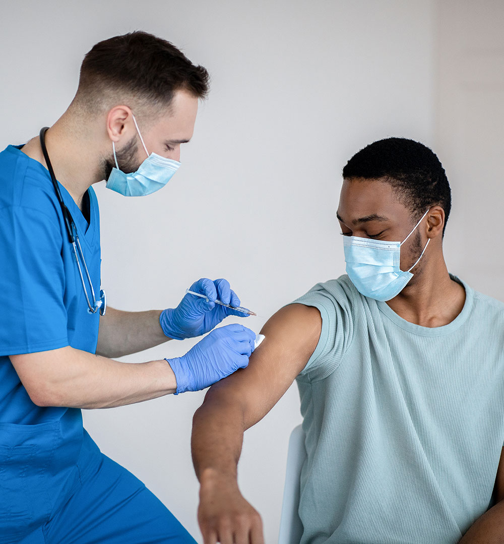 Healthcare worker giving the vaccine to a student?2024-04-23