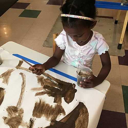 Child painting with mud