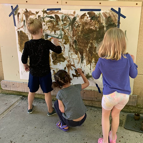 Children painting with mud