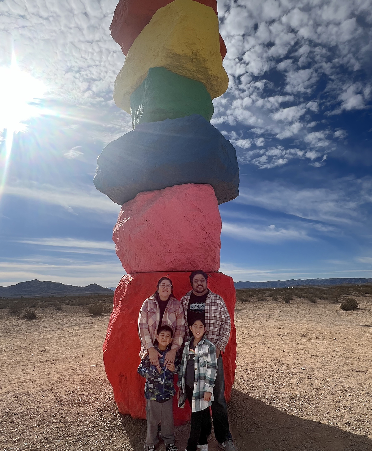 Michelle and her family standing in front of a colorful sculpture in t?2024-07-02