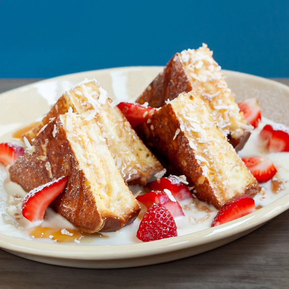 French toast with strawberries and powdered sugar.