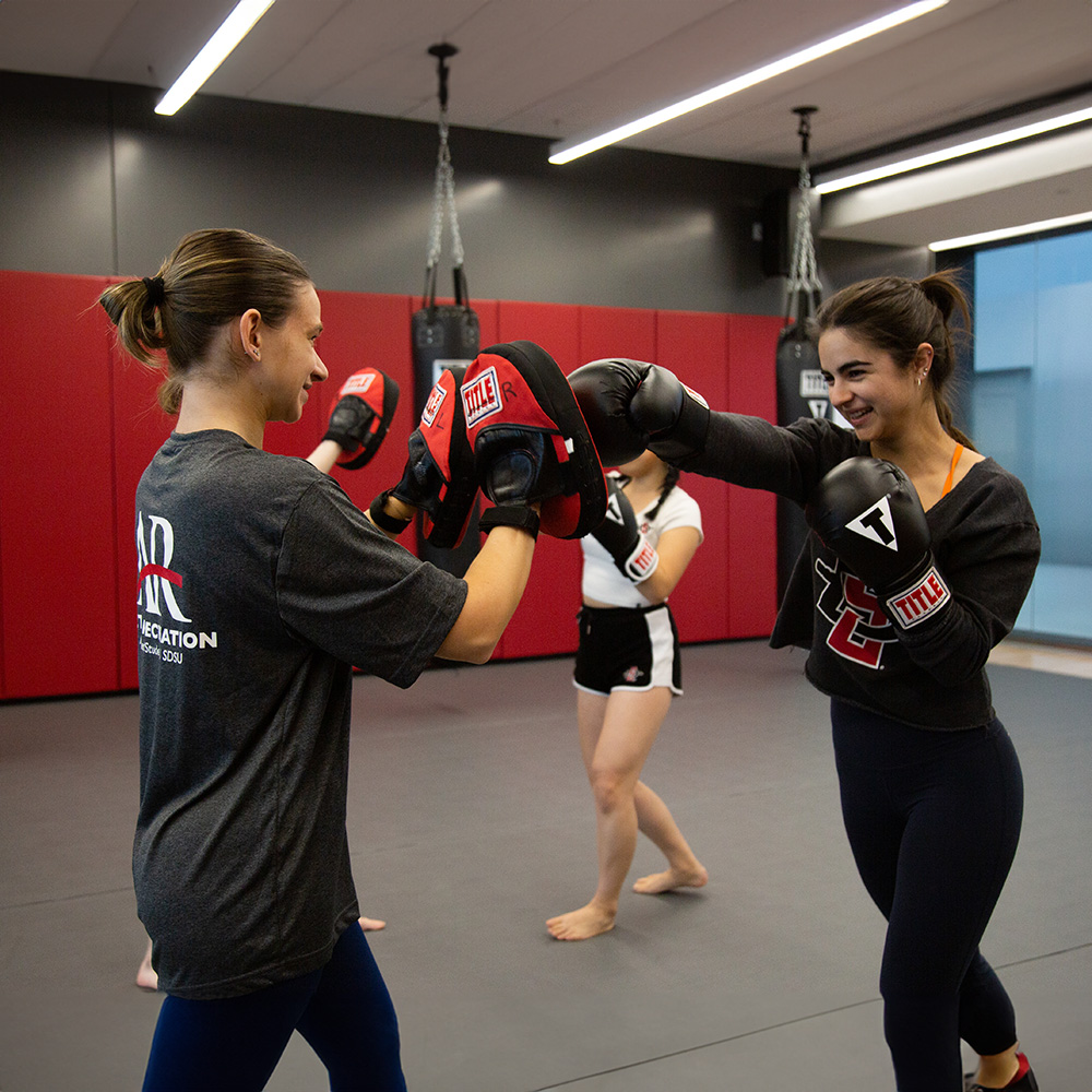 Women participating in boxing practice.