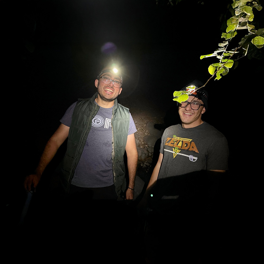Sam and company don headlamps at night.