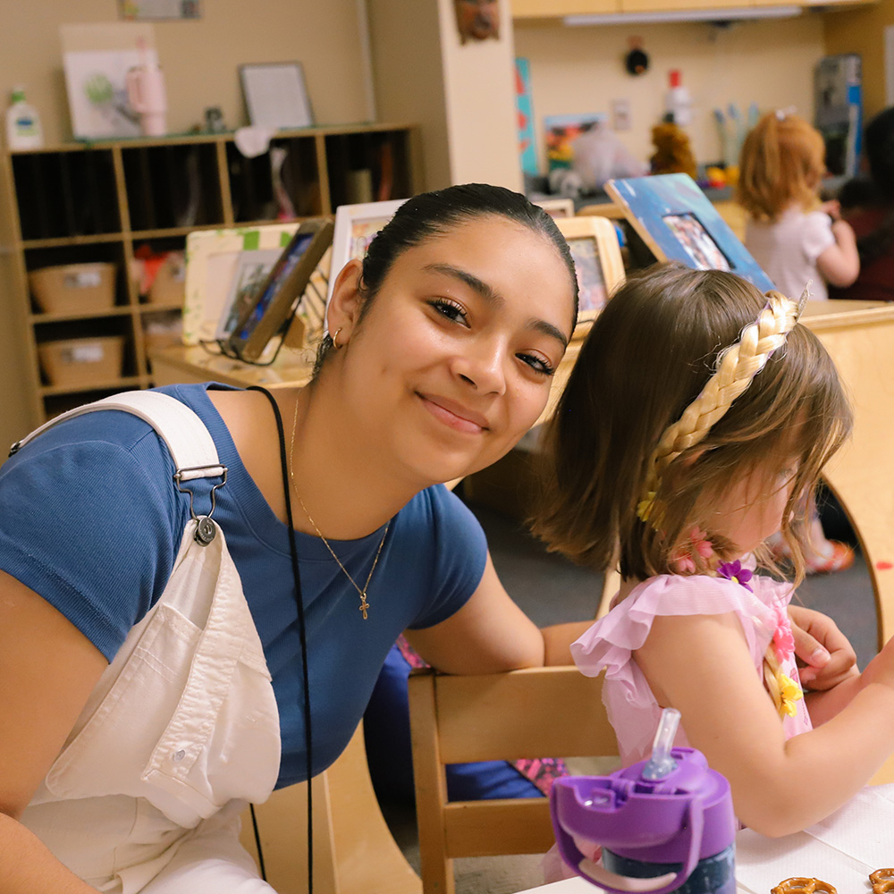A teacher from the Children's Center with one of her students.