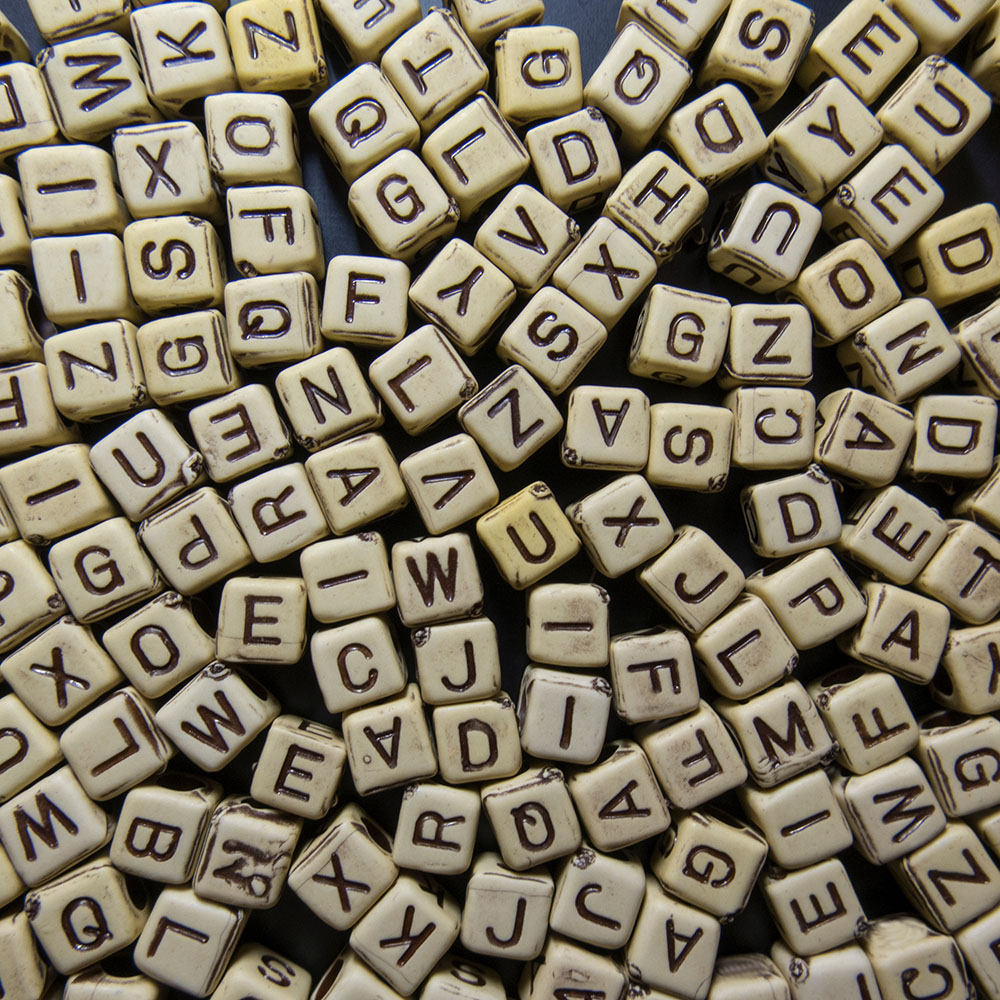 Various letter cubes in an indistinct pattern.