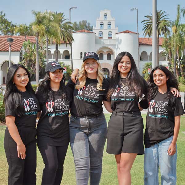 Five smiling ARH members in front of the Hepner Hall