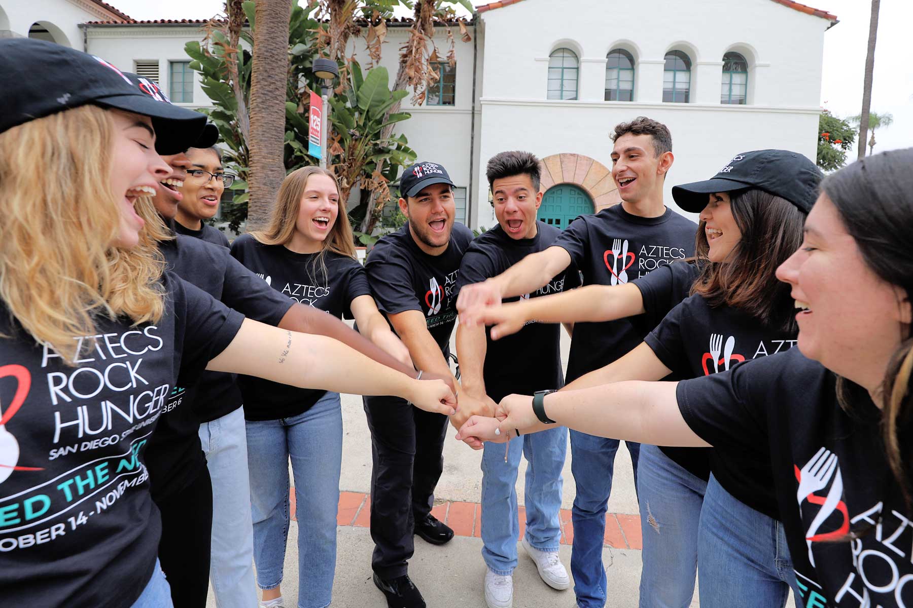 A group of ARH members performing hands-in cheer
